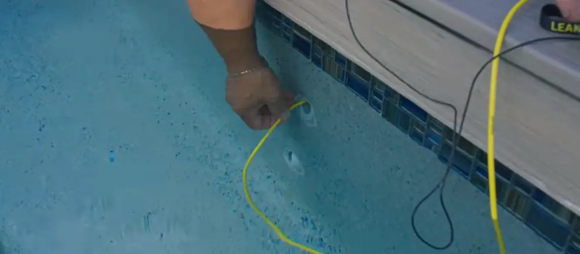 Electronic leak detection probe tracing a pool leak along the pool wall in Torrance